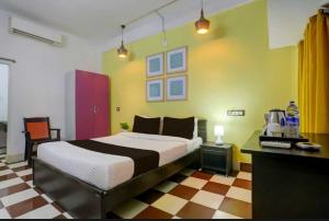 a bedroom with a large bed in a room at Hotel O Palasuni Bridge Bhubaneswar Formerly Ganpat in Mancheshwar