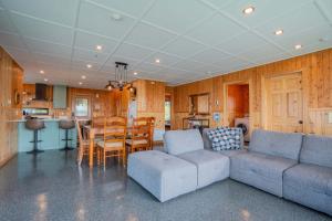 a living room with a couch and a table at Spa Nature & Comfort - Chalet LRioux in Trois-Pistoles +44 photos