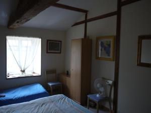 a bedroom with a bed and a window at La Revaudiere in Bressuire