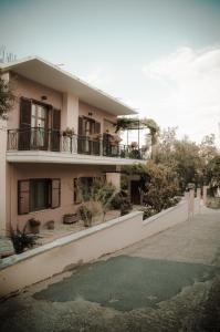 an apartment building with a puddle in front of it at Nefeli in Levidi