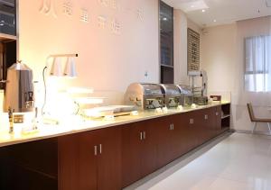 a kitchen with a counter with several dishes on it at City Comfort Inn Nanning Shanglin Longhu Road in Shanglin