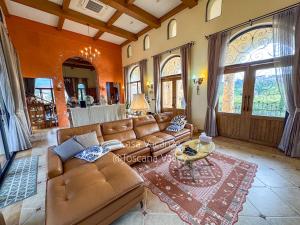 a living room with a couch and a table at Toscana valley, Casa Vacanze, Luxury private pool villa at Khao Yai in Ban Rai Khlong Sai