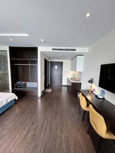 a large living room with a bed and a desk at Sapphire home S2 in Ha Long