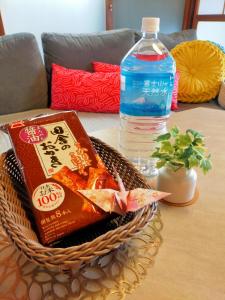a basket of food and a bottle of water on a table at 海雲 Kaiun Kawagoe リトル京都の和み宿 in Kawagoe