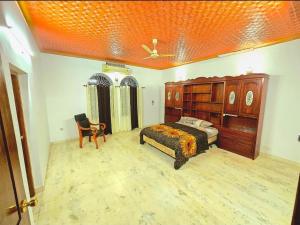 a bedroom with a bed and a chair in it at Janiszel Heaven- A Zion Legacy in Putuppalli