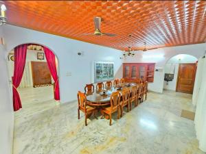 a large dining room with a table and chairs at Janiszel Heaven- A Zion Legacy in Putuppalli