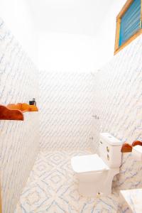 een badkamer met een wit toilet in een kamer bij Severini Villas Zanzibar in Nungwi