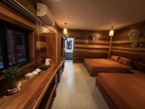 a bedroom with two beds and a table in it at Coco Bungalows in Koh Rong Sanloem