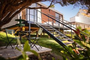 a staircase leading up to a house with a table and chairs at Bungalow da Romy in Vila Praia de Âncora