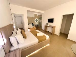 a hotel room with a bed and a television at La Costa Hotel in Katunayake