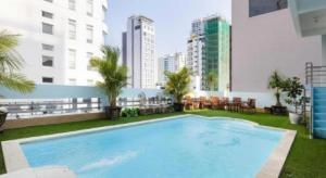 a large swimming pool on the roof of a building at Barcelona Hotel Nha Trang in Nha Trang