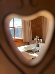 a table with a view of a dining room with a tableablish at Chalet Larchrast in Larcher