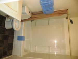 a bathroom with a shower with a white door at Macklin Motor Inn in Macklin