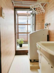 a bathroom with a sink and a window at Direct to Shinjuku 15 mins 3rooms Up to 7 Guests in Tokyo