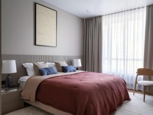 a bedroom with a large bed and a window at A27 Apartments in Almaty