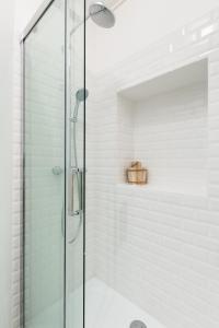 a shower with a glass door in a bathroom at Arlequin by Cocoonr in Rennes