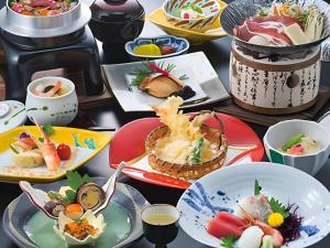 a bunch of plates of food on a table at Hotel Shofuen in Miya