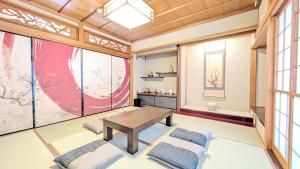 a room with a table and two pillows at LandHouse Kani Nagasaka in Kani