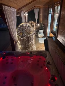 a hot tub in a room with a couch at Forest Home Dębowa 18 in Łuka +34 photos