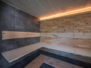 a sauna with a wooden bench in a room at Beautiful holiday home in a stunning location with sauna in Fügen