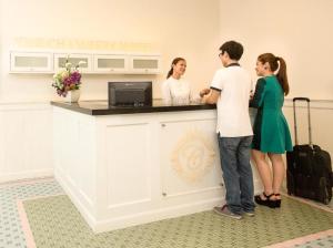 a group of people standing at a counter at The Chambers Hotel in George Town
