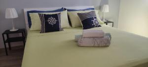 a large bed with pillows and a chair on it at Sky Blue Marine in Catania