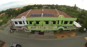 a building with a sign that reads one stop at OYO 90785 Pandan Hotel in Buang Sayan