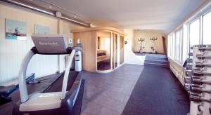 a room with a gym with a treadmill at Home Hotel Atlantic in Sandefjord