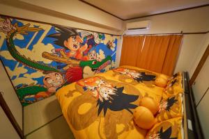 a bedroom with a bed with a spiderman mural at Kan'eiji-zaka Heim 寛永寺坂ハイム in Tokyo