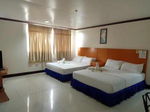 a hotel room with two beds in a room at Jeamco Royal Hotel - Pasig in Manila