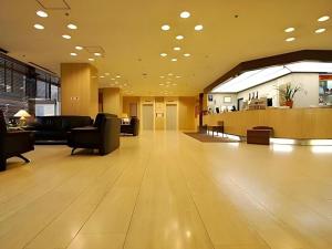 a large lobby with a waiting area and a waiting room at Sunroute Aomori Hotel in Aomori
