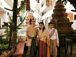 a group of three people standing in front of a building at Gudi Boutique Resort in Mae Rim +66 photos
