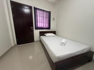 Postel nebo postele na pokoji v ubytování Balai Nyaman