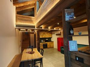 a kitchen and dining room with a wooden table at Le Grenier d'Antan - Relax Suite Aosta in Aosta