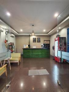 a large room with a store with a green counter at De Chukai Hotel in Cukai