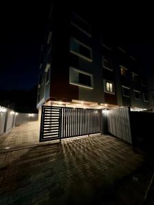 a fence in front of a building at night at Aesthetic 1BHK, Indore in Indore +31 photos