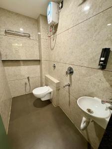 a bathroom with a toilet and a sink at Aesthetic 1BHK Elite, Indore in Indore +32 photos
