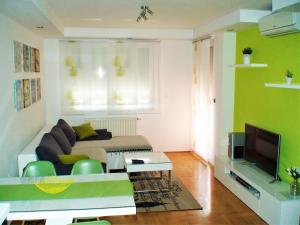 a living room with a couch and a tv at Luma Apartment in Zagreb