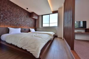 a bedroom with a large bed and a brick wall at Hotel Chalet Ryuo in Yamanouchi +16 photos