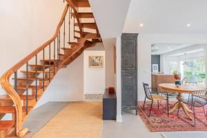 a staircase in a living room with a table and chairs at Errekaondo - baskeyrentals in Plentzia