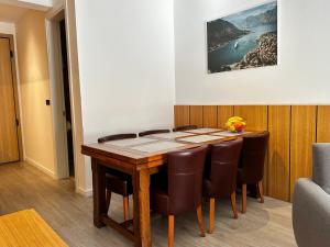 a dining room with a table and chairs at Dubrave apartmani in Budva