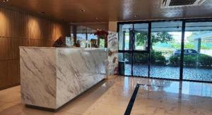 a lobby with a marble counter and a large window at ONE Residence in Ban Lam Rua Taek +90 photos