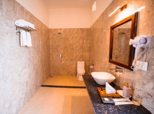a bathroom with a sink and a mirror at Ranthambhore Ghati in Sawāi Mādhopur +43 photos