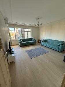 a living room with a blue couch and a television at İsmail Yılmaz Hotel in Trabzon