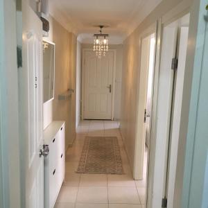 a hallway with a white door and a chandelier at Kinzi House in Canakkale