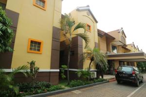 a car parked in front of a building at Hotel Permata Bandara in Gombolpaya