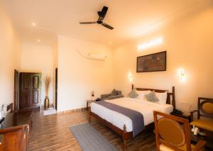 a bedroom with a bed and a ceiling fan at Ranthambhore Ghati in Sawāi Mādhopur