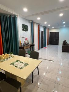 a room with a table and chairs and curtains at GL Homestay in Sibu