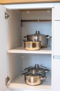 two pots and pans in a kitchen pantry at Mobile homes Jezera Lovišća Premium in Jezera