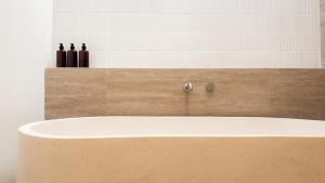 a bathroom with a bath tub in a room at Prana Ubud in Tegalalang